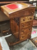 19th century davenport desk with three-quarter gallery top, the fall with red leather inset and