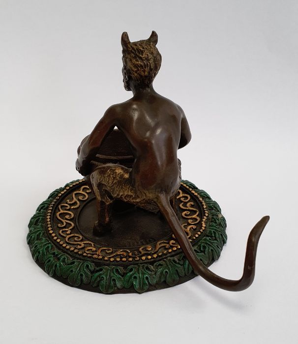 Bronze model of a faun holding a large vase, on a circular base, gilt and green painted, with - Image 2 of 4