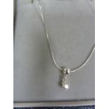Solitaire diamond drop pendant, claw-set in silver mount, on fine chain, the stone approx 0.10ct