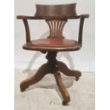 Oak office swivel chair with brown leather seat, the whole raised on castors
