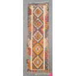 Maimana kilim runner with orange and blue lozenges on a brown ground, 203cm x 62cm