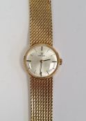 Lady's 18ct gold Omega wristwatch with circular dial, baton numerals, integral flexible mesh