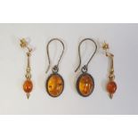 Pair of 9ct gold drop earrings, each set with an oval amber cabochon and a pair of silver and