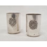 Pair of mid to late 19th century Russian silver shot glasses with relief crest and engraved