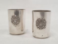 Pair of mid to late 19th century Russian silver shot glasses with relief crest and engraved