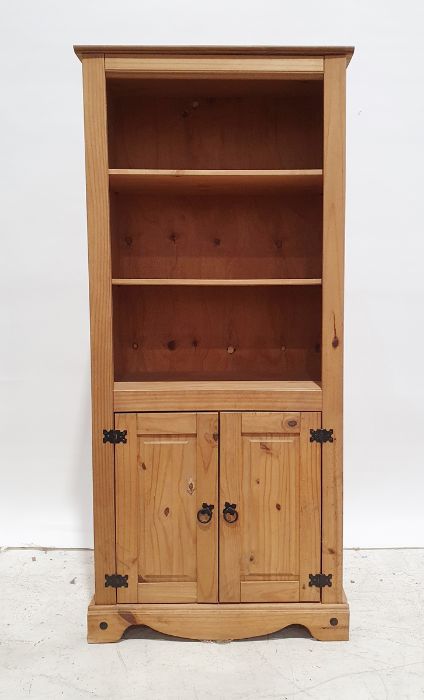 Pair of 20th century pine bookcases, two adjustable shelves above two cupboard doors, bracket