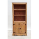 Pair of 20th century pine bookcases, two adjustable shelves above two cupboard doors, bracket