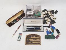 Quantity of commemorative coins, a set of dominoes, Parker pens, etc