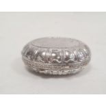 A silver oval trinket box, border decorated with fleur-de-lis, gilded interior, marked 925 and