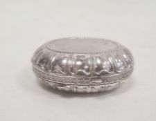 A silver oval trinket box, border decorated with fleur-de-lis, gilded interior, marked 925 and