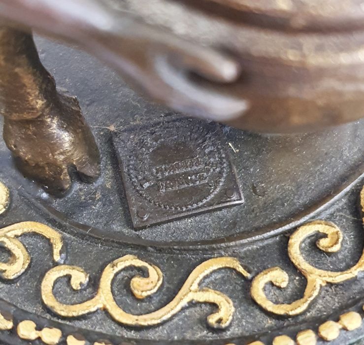 Bronze model of a faun holding a large vase, on a circular base, gilt and green painted, with - Image 4 of 4