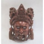 Chinese carved hardwood mask depicting a man's face, with his headdress surmounted by dragons,
