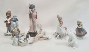 Quantity of Lladro figures to include Geisha girl, polar bear, girl grooming dog, boy with