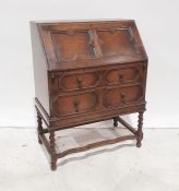 20th century oak bureau of two long drawers, shaped stretchers, barley twist and block supports,