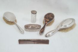 Three silver-mounted dressing brushes with inset silver and tortoiseshell, a silver-mounted comb and
