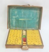 Cased mahjong set in leather case  Condition Report 148 tiles. All seem to be red backed.