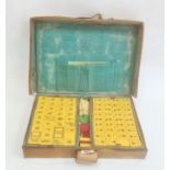 Cased mahjong set in leather case  Condition Report 148 tiles. All seem to be red backed.