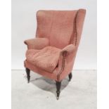 19th century barrel back armchair in pink ground upholstery, turned and reeded front legs to brass