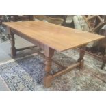 20th century oak table, rectangular top on turned and block supports, stretchered base, 184cm long