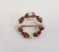 9ct gold wreath brooch of circular form set with alternating cultured pearls and red stones, approx.