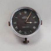 Mid 20th century British Jaeger Automobile clock, the ebonised dial with Roman numerals, marked '