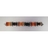 Antique silver and agate bracelet, the six shaped agate panels striped in shades of brown, orange