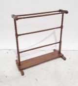 Early 20th century mahogany towel rack, bobbin end supports, plank stretcher