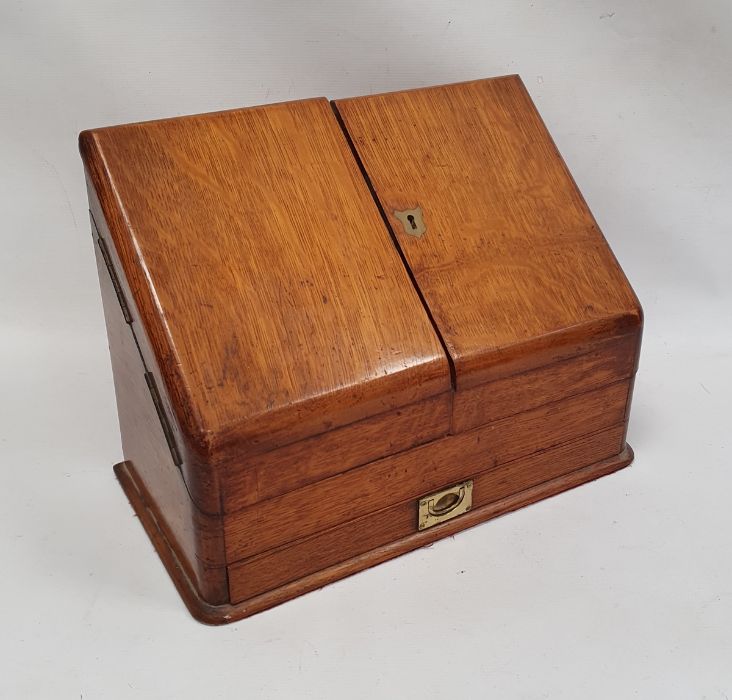 Late 19th/ early 20th century oak desk tidy the twin doors opening to reveal sectioned interior,