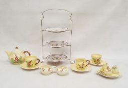 Carlton ware teapot of yellow leaf design, with hollyhock decoration, a matching cup and saucer,