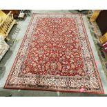 Modern red ground rug with allover foliate decoration, cream ground foliate decorated border,