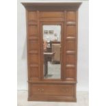 Early 20th century oak single door wardrobe, moulded cornice, panel decoration, mirror to door above