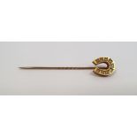 Victorian gold-coloured stickpin with horseshoe finial, set with nine diamonds, marked 15