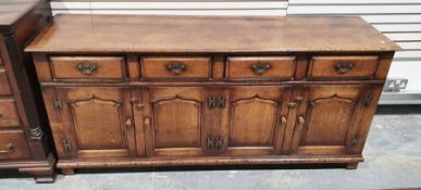 20th century oak low dresser, rectangular top, four short drawers above cupboards, stile supports,