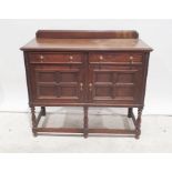 20th century oak sideboard, rectangular top, moulded edge, two drawers, two cupboard doors, turned