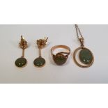 14k gold and green jade type stone pendant with oval pendant drop within twisted border on fine