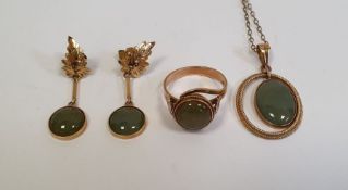 14k gold and green jade type stone pendant with oval pendant drop within twisted border on fine