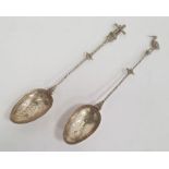 A pair of silver spoons, possibly Dutch one with windmill to handle and the other with stork, marked