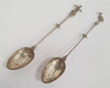 A pair of silver spoons, possibly Dutch one with windmill to handle and the other with stork, marked