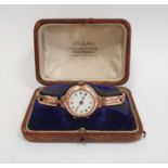 A lady's 9ct gold wristwatch, Roman numerals to the white enamel dial, in a Penlington & Batty
