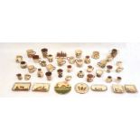 Large quantity of motto ware pottery including a toast rack, cups, jugs, egg cups, etc