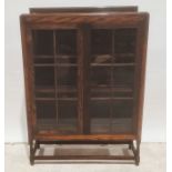 Early 20th century oak bookcase, the astragal glazed doors enclosing shelves, turned and block