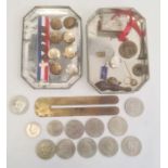 Vintage tin containing various military buttons and assorted coins in clear plastic bag (2)