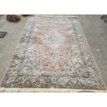 Modern Eastern-style rug, peach ground foliate decorated field with pale green central medallion and