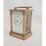 Brass and glass five-sided carriage clock with Roman numerals, bracket feet