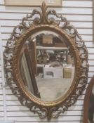 Oval mirror in modern moulded acanthus leaf frame