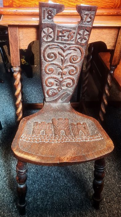 Late 19th century oak chair, the carved back dated 1875 with the initials F.D.C, the seat with