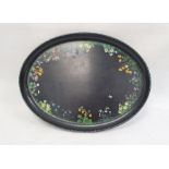 Papiermache tray of oval form, decorated with wild flowers, on a black ground, 51cm long, and two