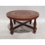 Circular coffee table with brown leather top with aztec design, on turned and block supports,