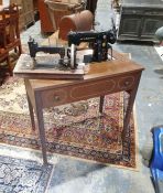 Singer sewing machine in table and one further sewing machine (2)