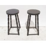 Two 20th century black painted stools